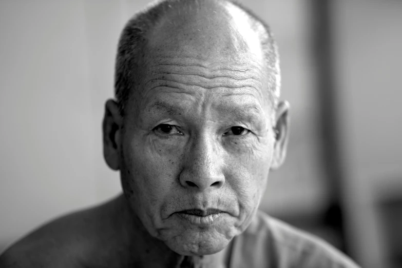 a black and white photo of an older man, inspired by Kiyoshi Yamashita, portrait of bald, south east asian with round face, concerned expression, kano tan'yu