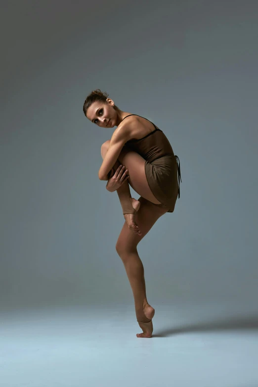 a woman in a brown leo leo leo leo leo leo leo leo leo leo leo leo leo, inspired by Elizabeth Polunin, arabesque, getty images proshot, default pose neutral expression, studio, jamie coreth