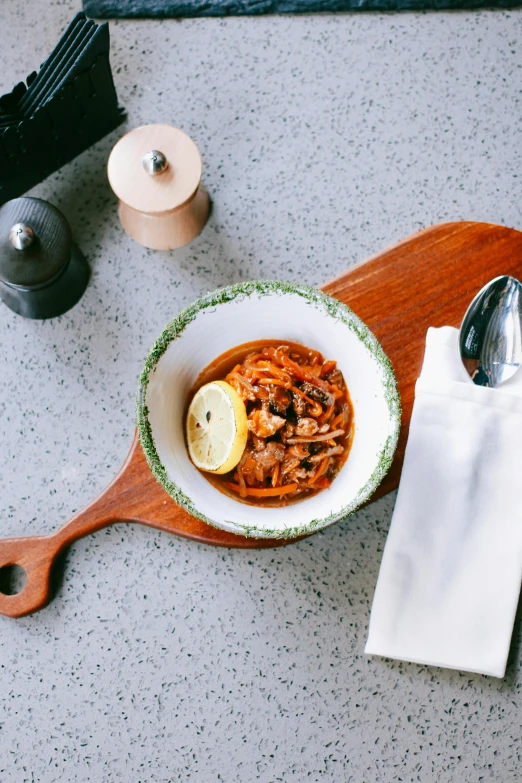 a bowl of food sitting on top of a wooden cutting board, renaissance, spoon, daily specials, caulfield, pasta