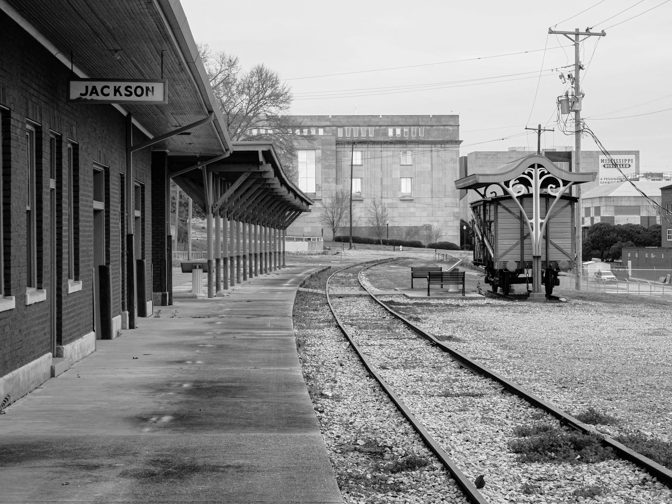 a black and white photo of a train station, a black and white photo, by Jim Manley, bentonville arkansas, square, yard, complex and desaturated