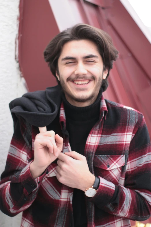 a young man holding a lighter in his hand