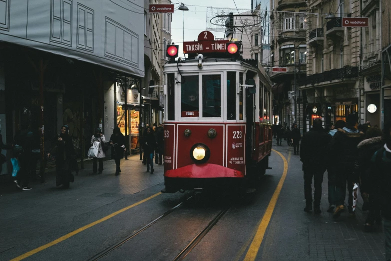 an electric trolley is in the middle of an urban area