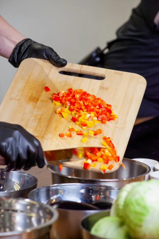 a person cutting vegetables on a cutting board, performance, chunky gauntlets, salsa tricks, gourmet style