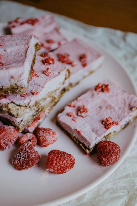 a close up of a plate of food on a table, by Valentine Hugo, unsplash, romanticism, raspberry banana color, cakes, freezing, natural soft light