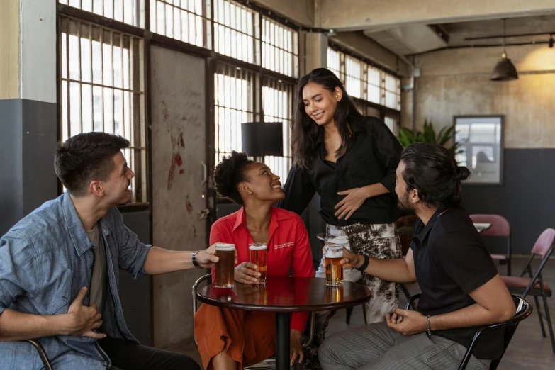 a group of people sitting around a table with drinks, on a table