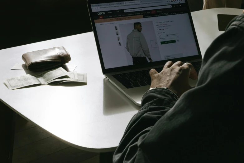 a person sitting in front of a laptop computer, trending on pexels, hyperrealism, techwear clothes, low quality photo, thumbnail, ecommerce photograph