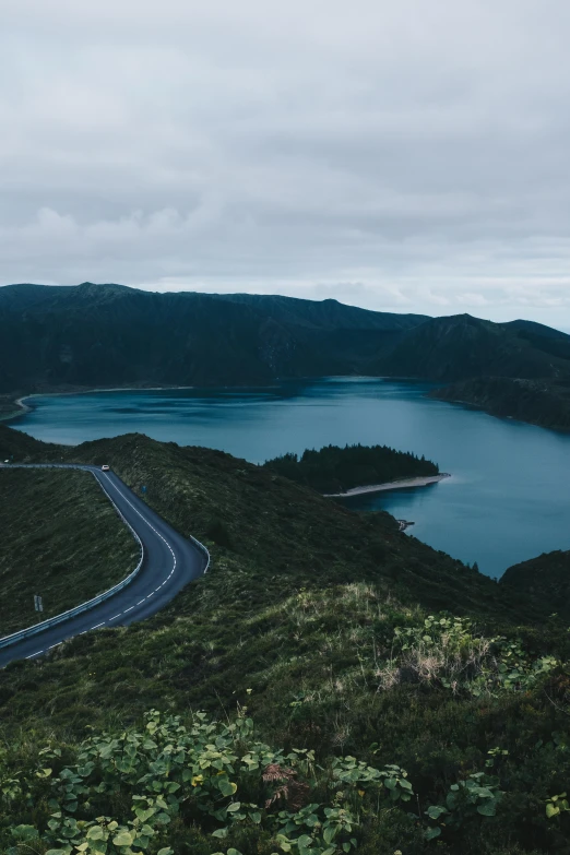 the winding road with the lake below them