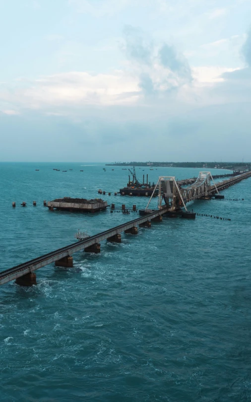 a long bridge over a body of water, happening, india, dredged seabed, shot with premium dslr camera, oil rig