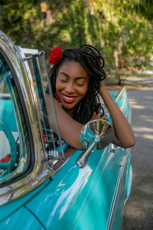 a woman leaning out the window of a car