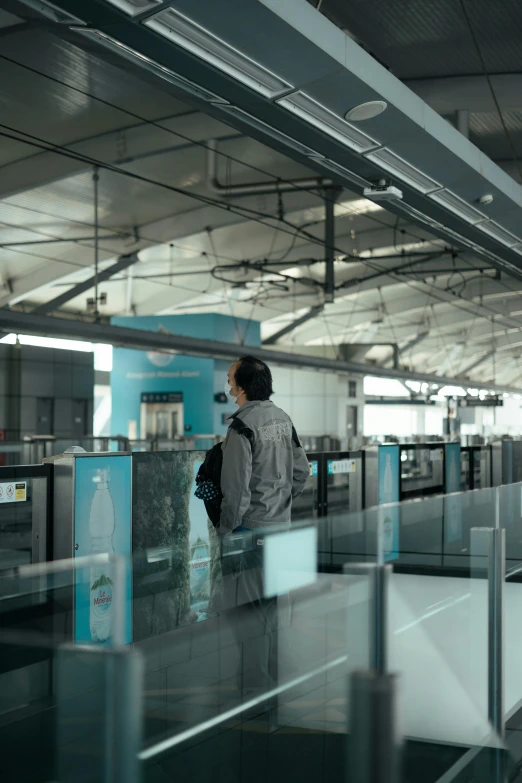 a woman is waiting for her luggage at the airport, by jeonseok lee, pexels contest winner, happening, stood inside a futuristic lab, man standing, ice gate, taiwan