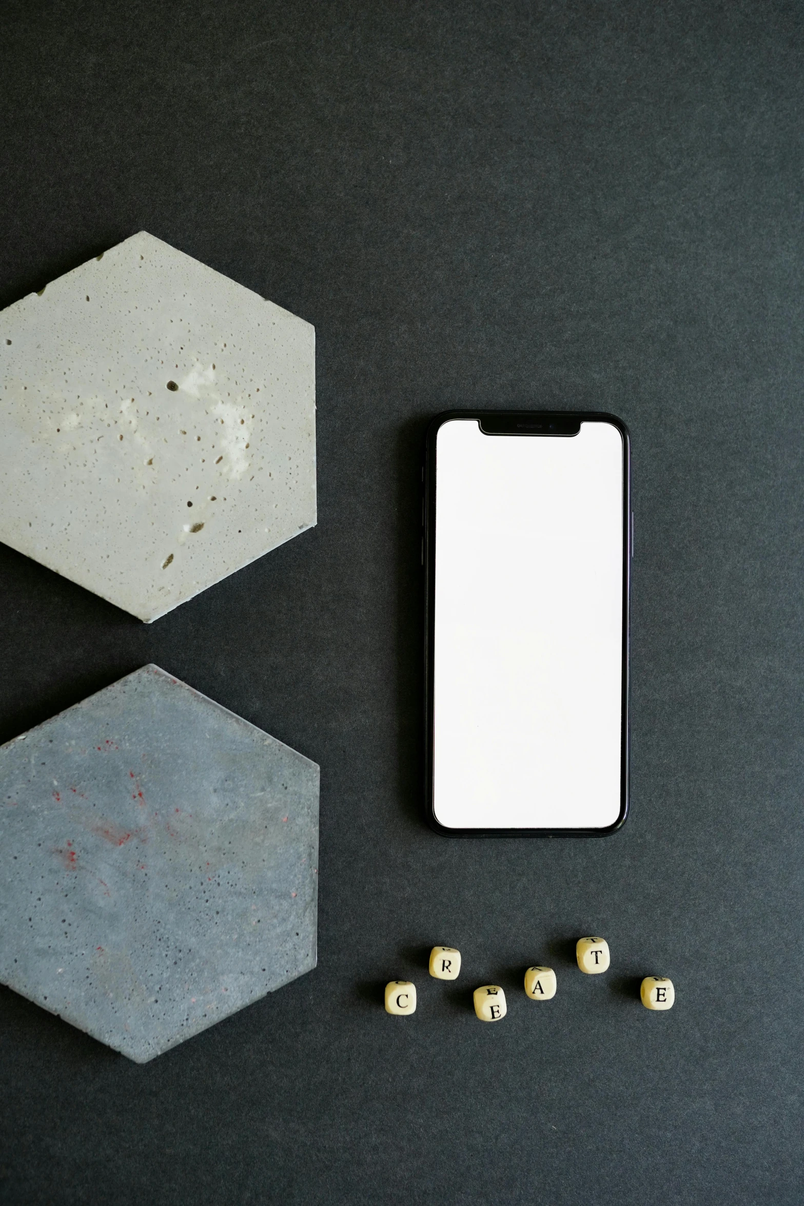 a cell phone sitting on top of a table next to dice, pexels contest winner, concrete art, 2 5 6 x 2 5 6, hexagonal wall, no - text no - logo, sleek white