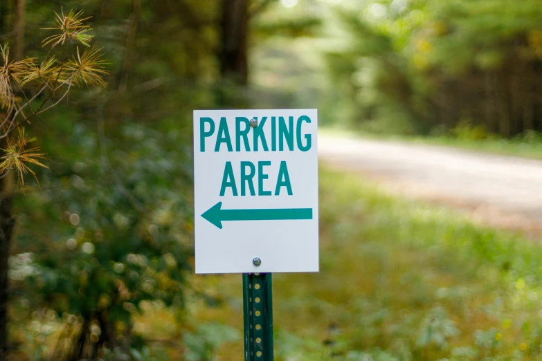 a street sign on a wooden pole on a path