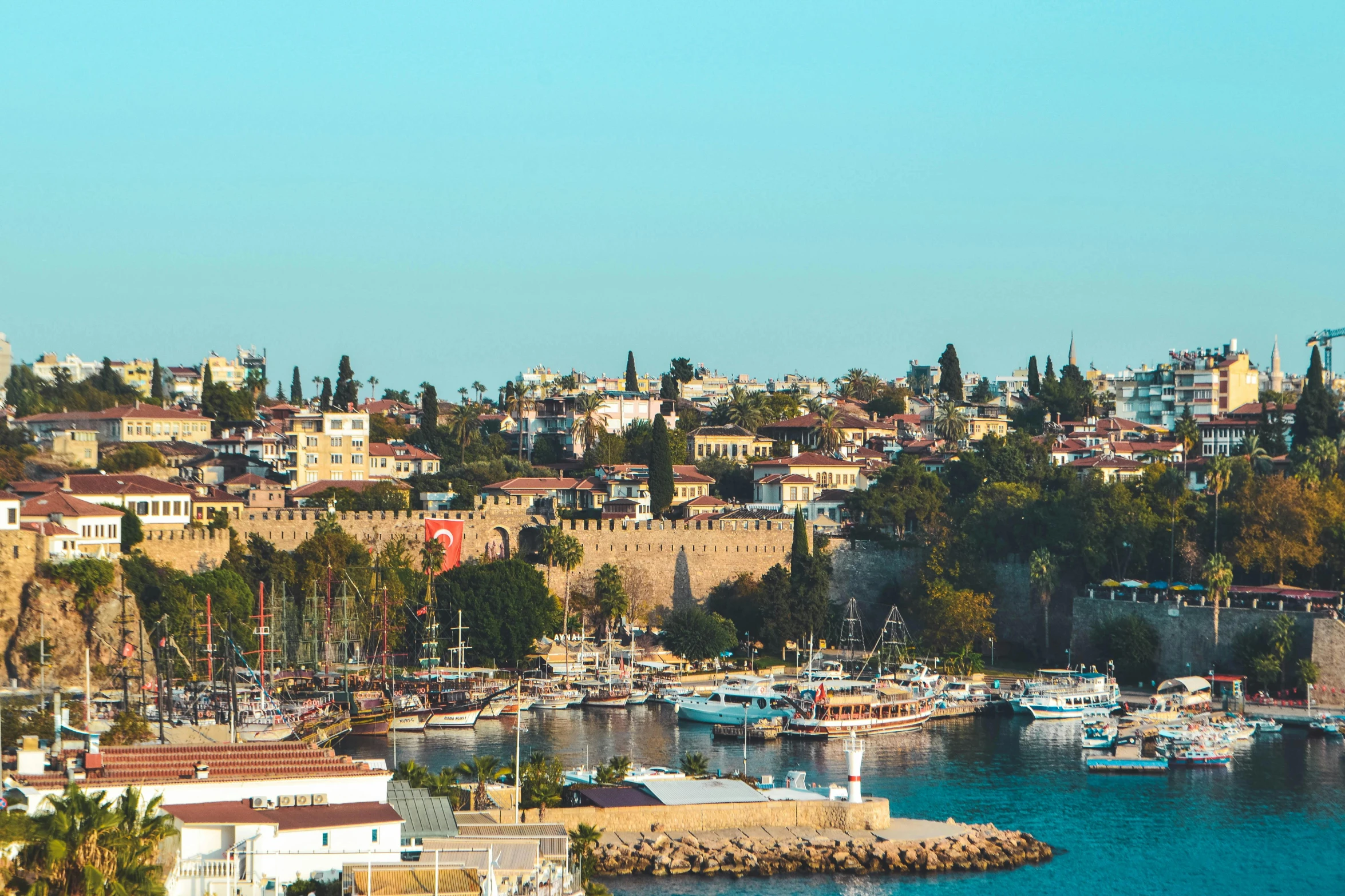 a large body of water filled with lots of boats, pexels contest winner, hurufiyya, city walls, clear and sunny, turkey, 💋 💄 👠 👗