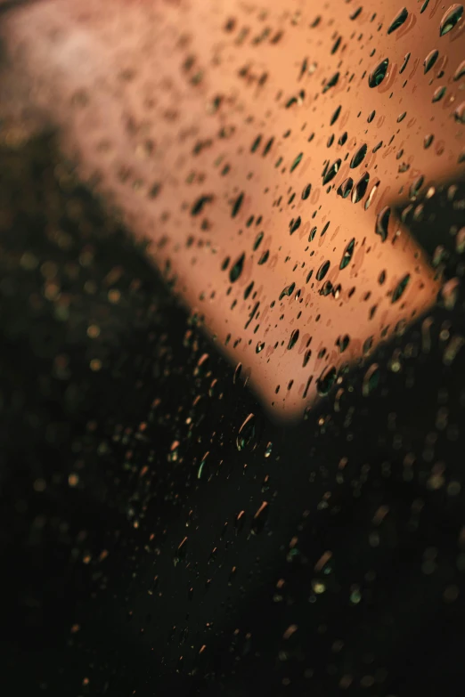 a close up of a window with raindrops on it, an album cover, inspired by Elsa Bleda, trending on unsplash, tonalism, sweat drops, alessio albi, with a black background, scratches and burns on film