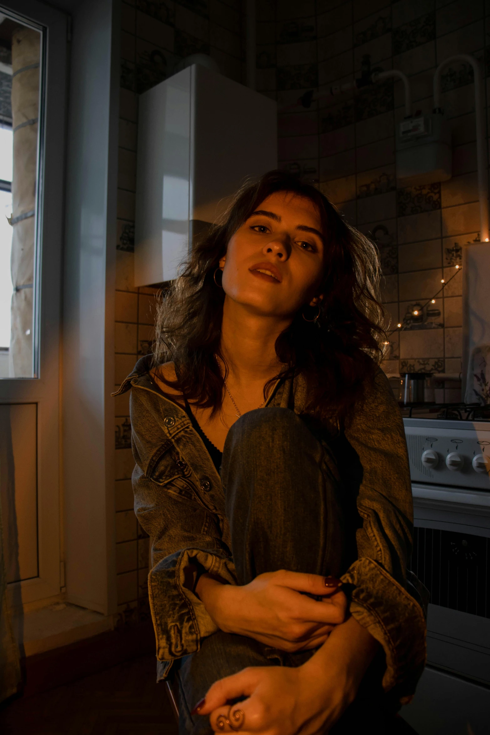 a woman stands in a kitchen holding a pot