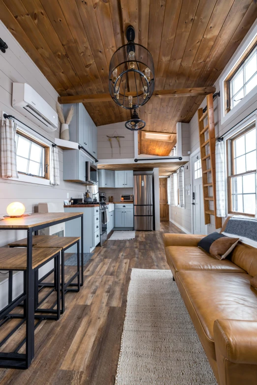 a couch and table are set up in this modern style cabin