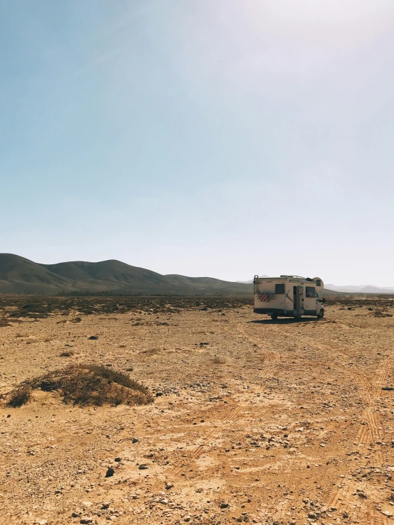 the old truck is sitting alone in the desert