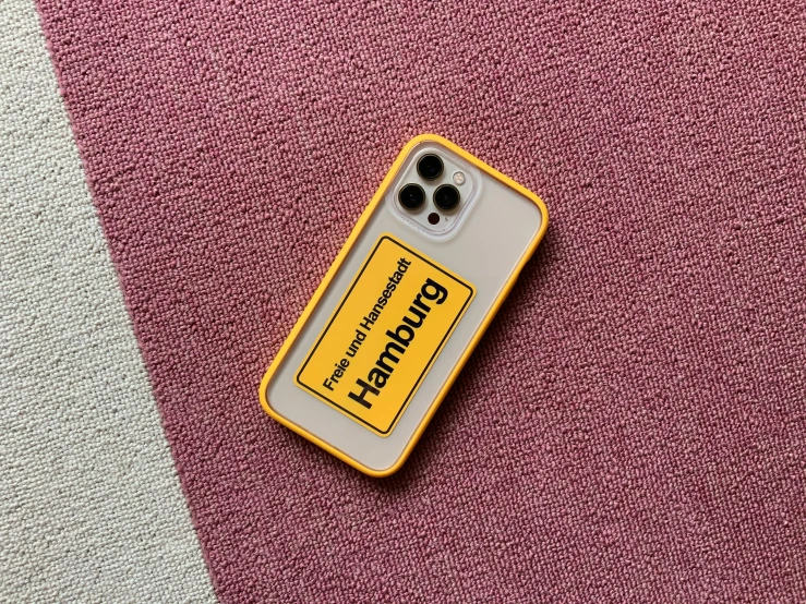 a yellow phone case sitting on top of a pink carpet, a picture, by Niels Lergaard, a labeled, offwhite, morhbacher, gen z