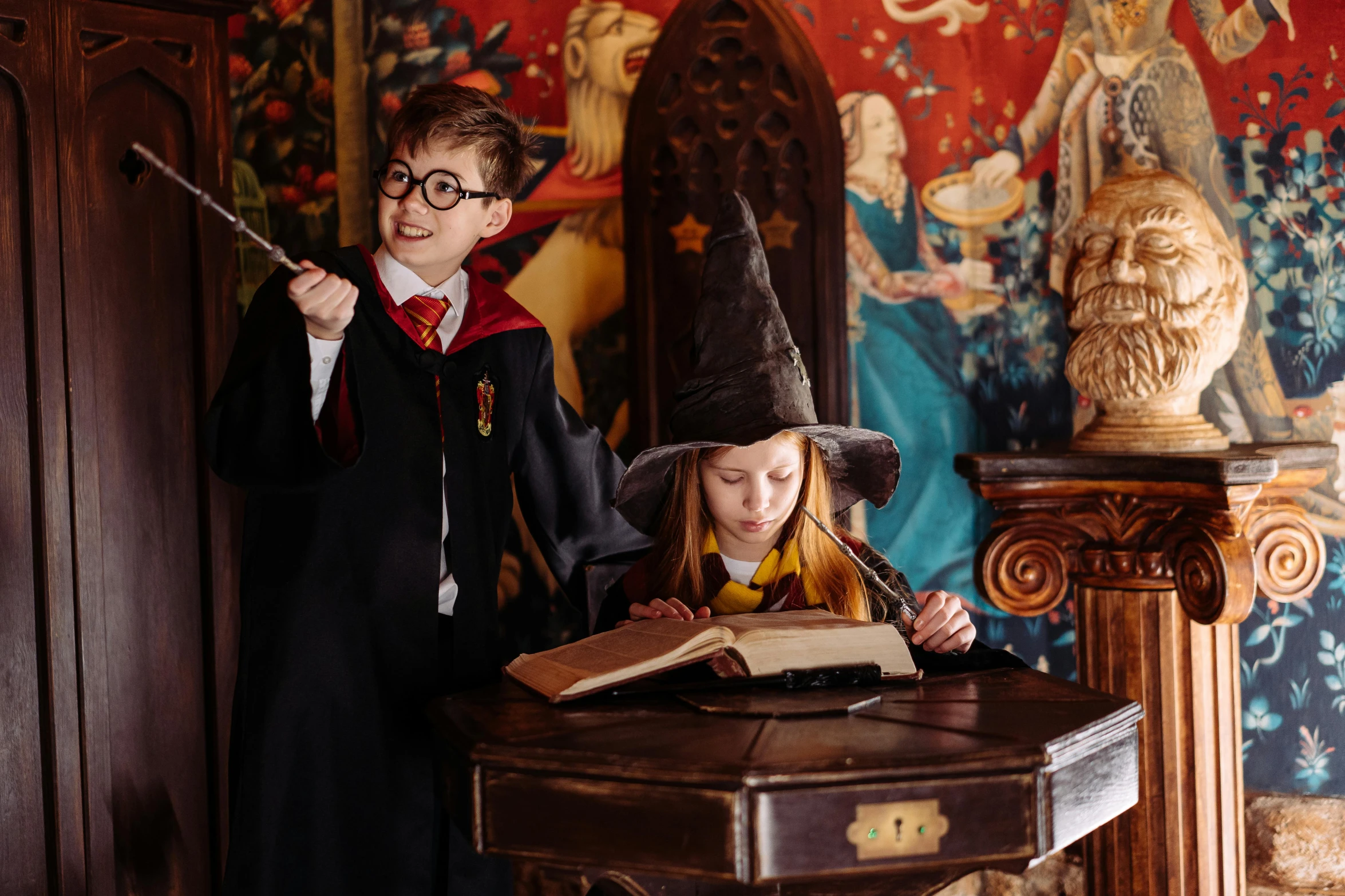 a couple of kids that are standing in front of a table, wizard themed, immersive, hogwarts, indoor picture