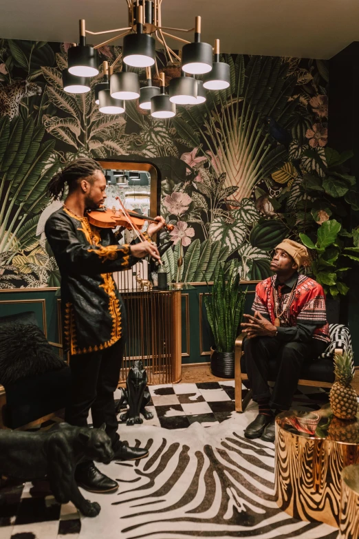 man playing violin in a music room with other musicians