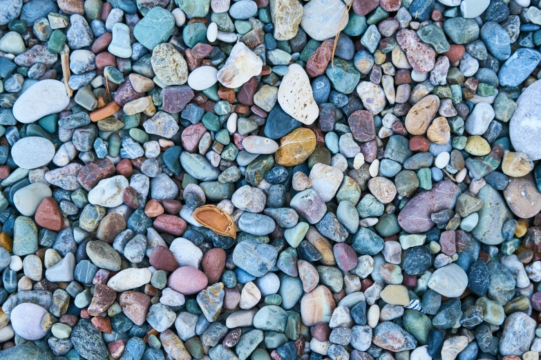 a pile of rocks sitting on top of a beach, an album cover, unsplash, seamless texture, multicolored, ((rocks))