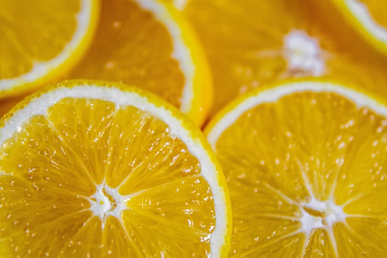 a close up of a bunch of orange slices, by Carey Morris, pexels, 🦩🪐🐞👩🏻🦳, yellow-orange, lemonade, ultra detailed close up