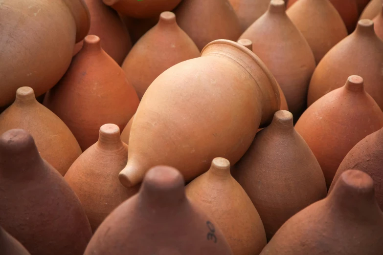 a bunch of clay pots stacked on top of each other, by Jessie Algie, trending on unsplash, moroccan, paul barson, amphora, close-up product photo