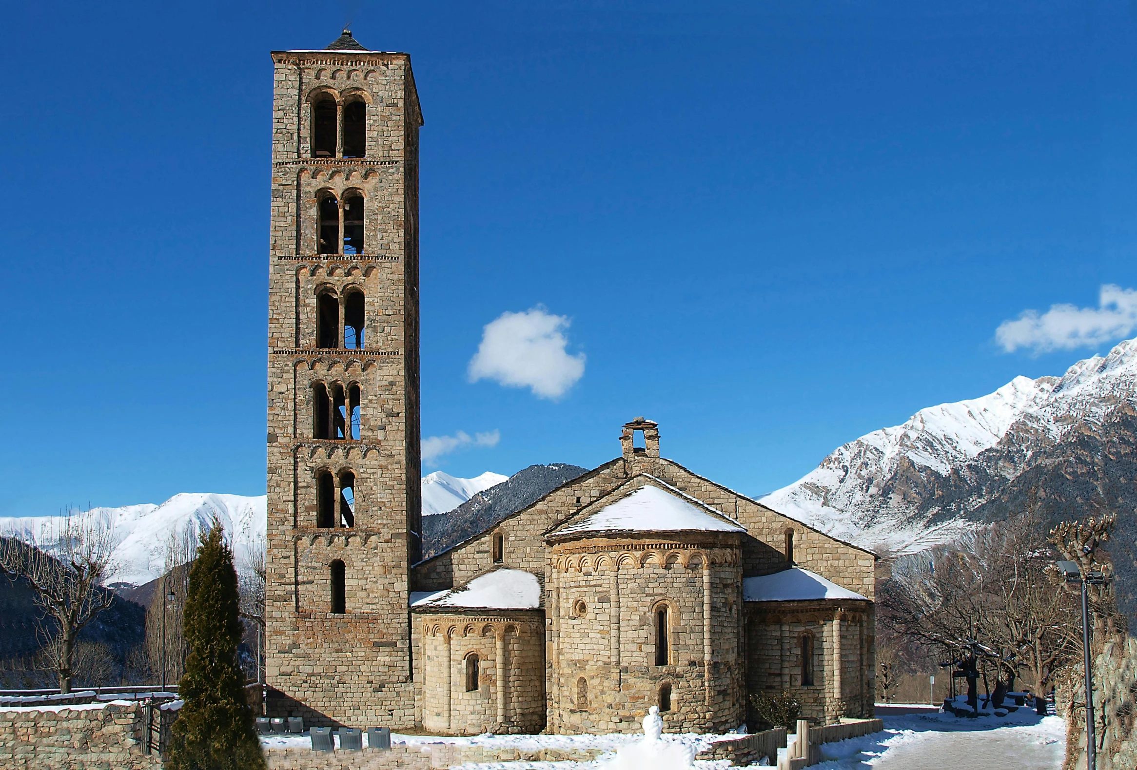 a tall clock tower sitting in the middle of a snow covered field, inspired by Peter Zumthor, pexels contest winner, romanesque, exterior view, alp, blue, panorama