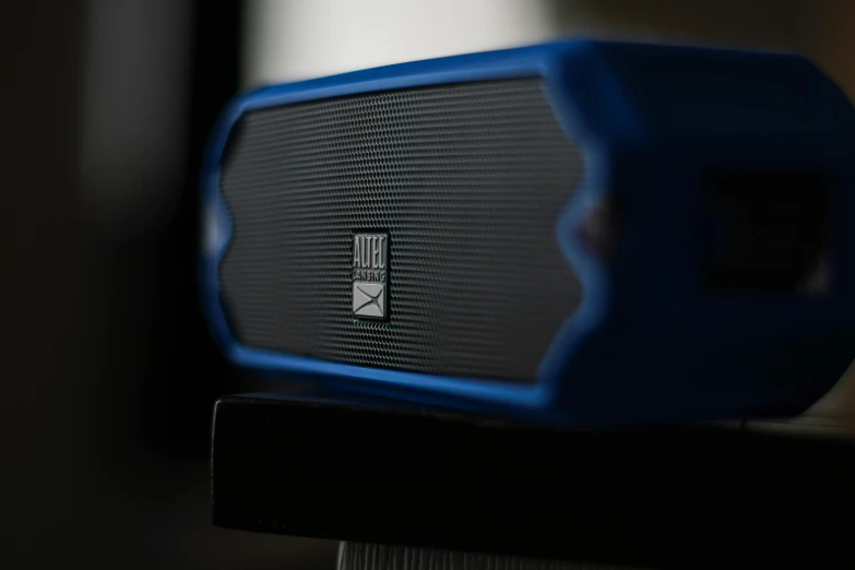 a blue speaker sitting on top of a wooden table, zoomed in, square, kobalt blue, boombox