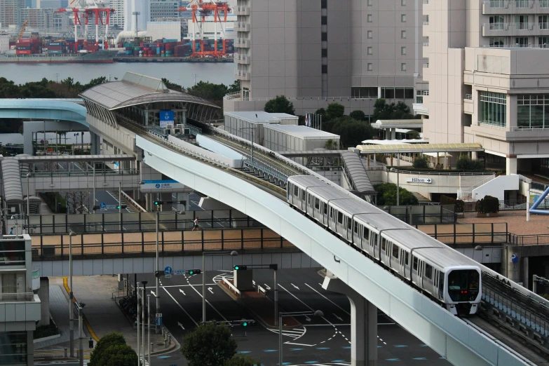 a large long train on a steel track, sōsaku hanga, skybridge towers, afp, taken in 2 0 2 0, getty images