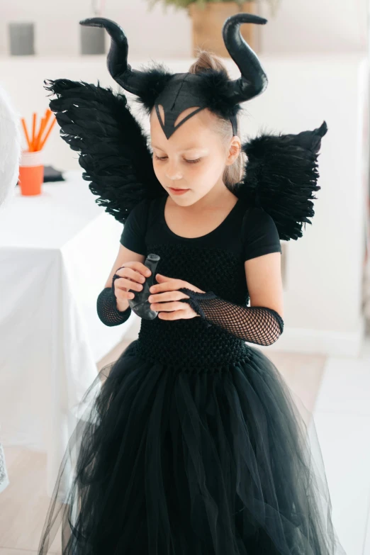 a little girl dressed up in a black dress, with hooves and wings, wētā fx, bella poarch, young harpy-girl