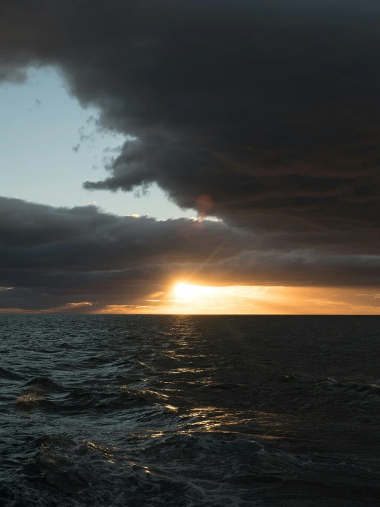 a boat out on the water at sunset