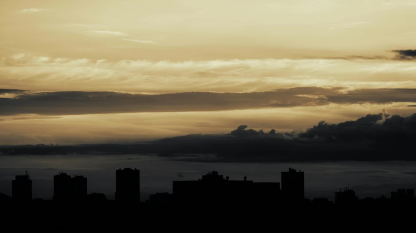 a plane flying over a city under a cloudy sky, by Mathias Kollros, pexels contest winner, tonalism, silhouette :7, golden towers, glasgow, panorama view of the sky