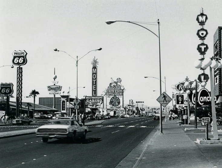 a black and white photo of a city street, by Dennis Ashbaugh, bernie goes to vegas, museum archive photo, van, ap photo