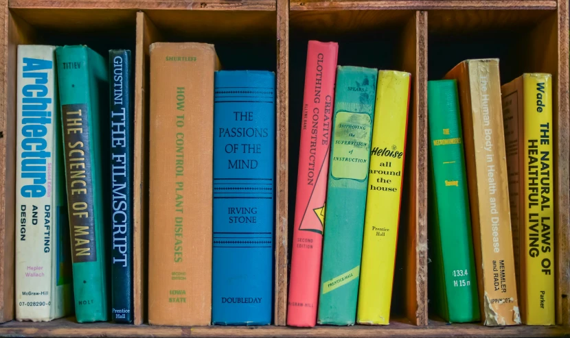 a row of books sitting on top of a wooden shelf, yellow and green scheme, thumbnail, old school, featured