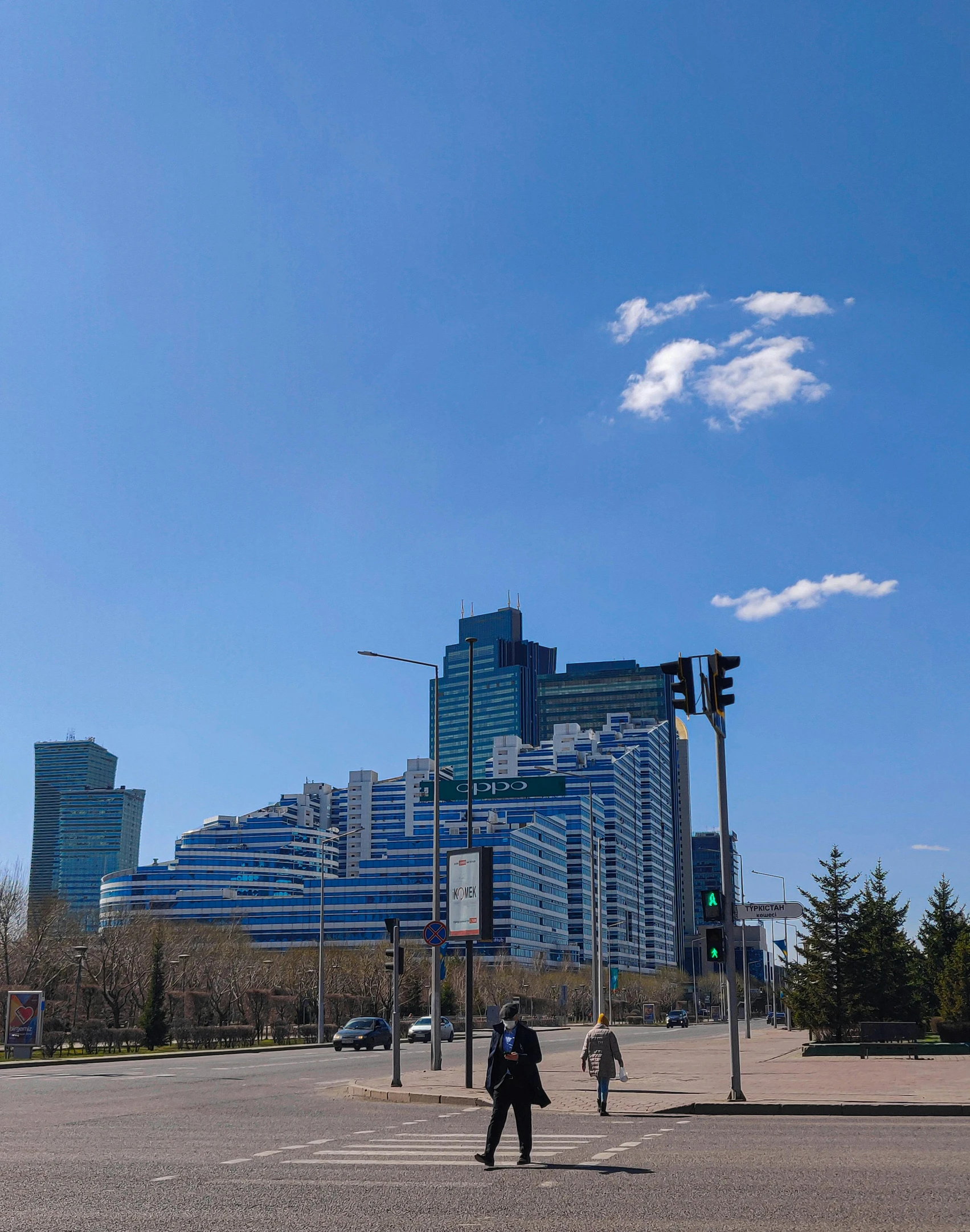 a couple of people walking across a street, an album cover, pexels contest winner, socialist realism, mongolia, skyscapers, perfect spring day with, low quality photo