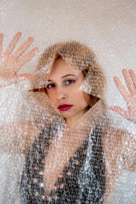 a woman is shown through the plastic covering her face