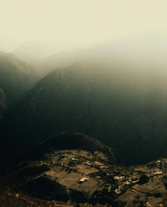 the top of a hill covered in fog