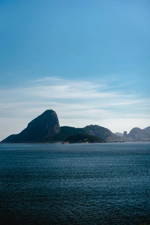 a large body of water with mountains in the background, by Elsa Bleda, cristo redentor, square, coastline, slide show