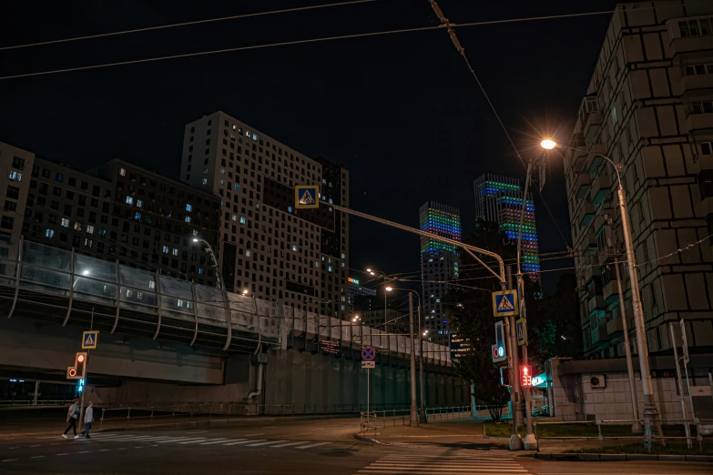 an empty city street at night with traffic lights