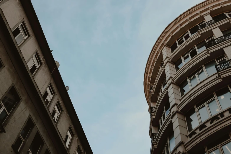 two buildings and an airplane in the sky