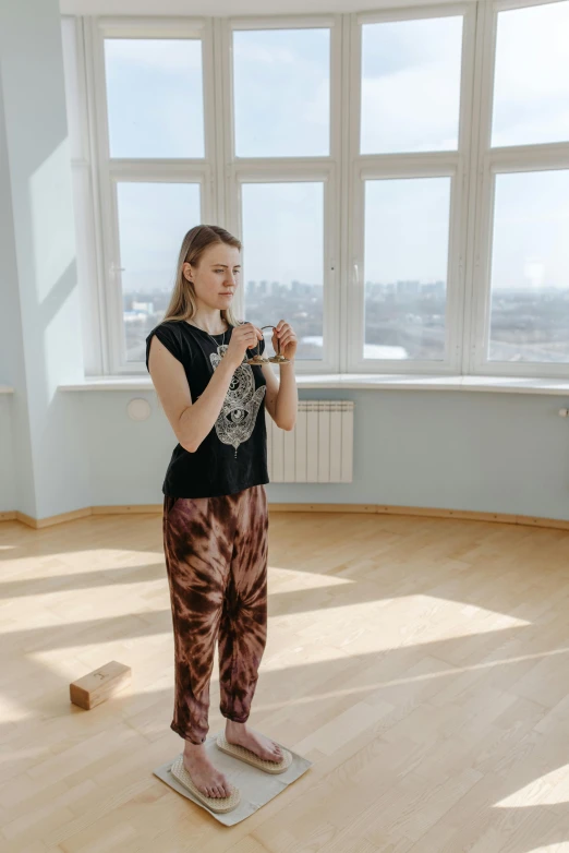 a woman standing on a scale in a room, an album cover, pexels contest winner, russian academic, young girl playing flute, high quality photo, yoga