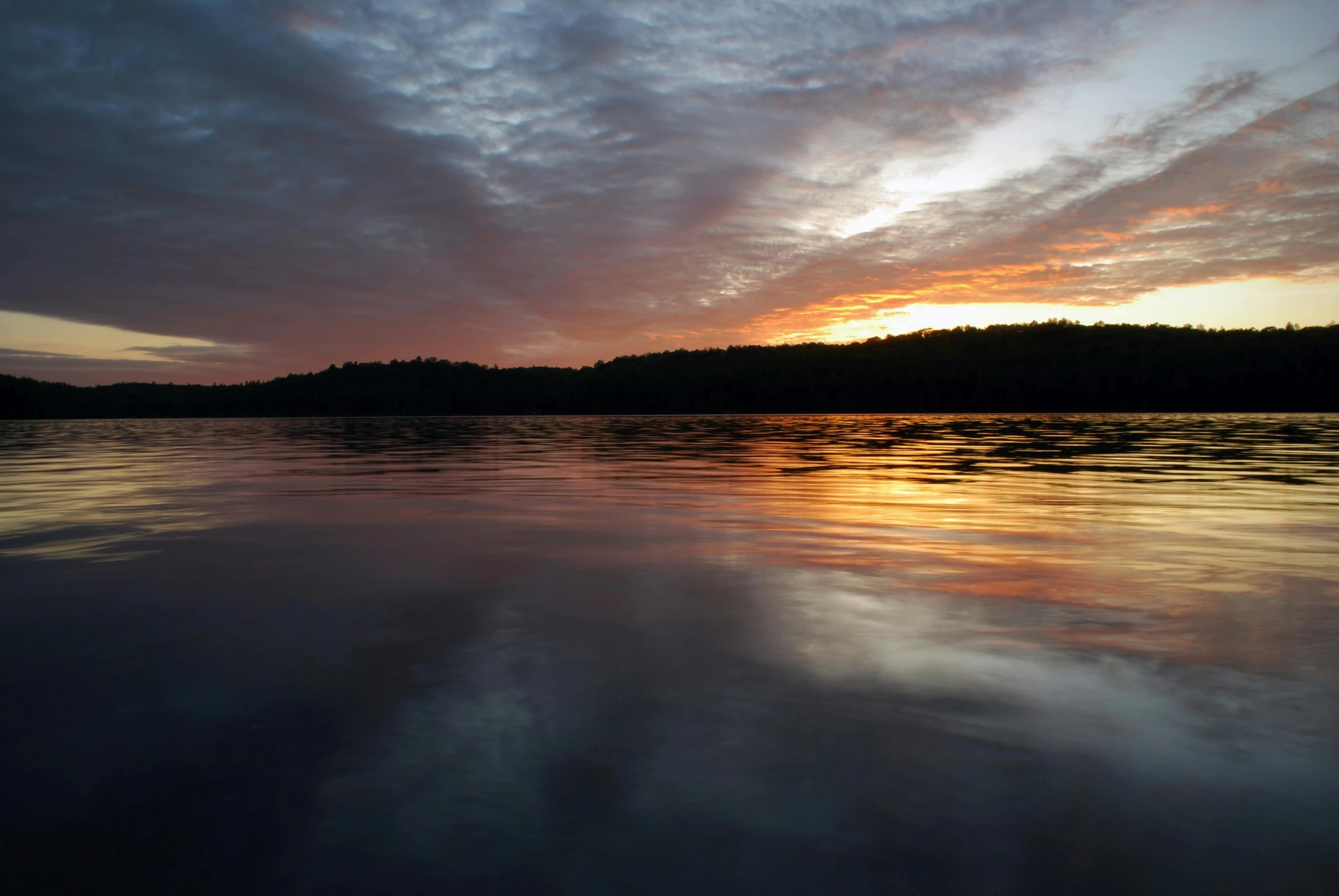 the sky is reflecting off of the surface of water