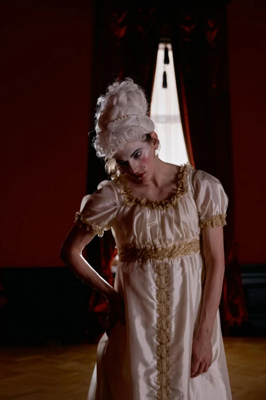 a woman in a long white dress is posing for the camera