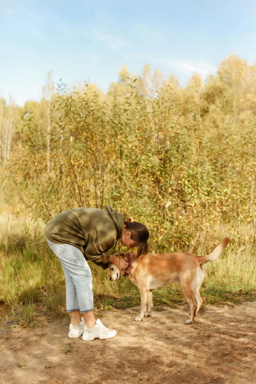 man and his dog playing outside in a field