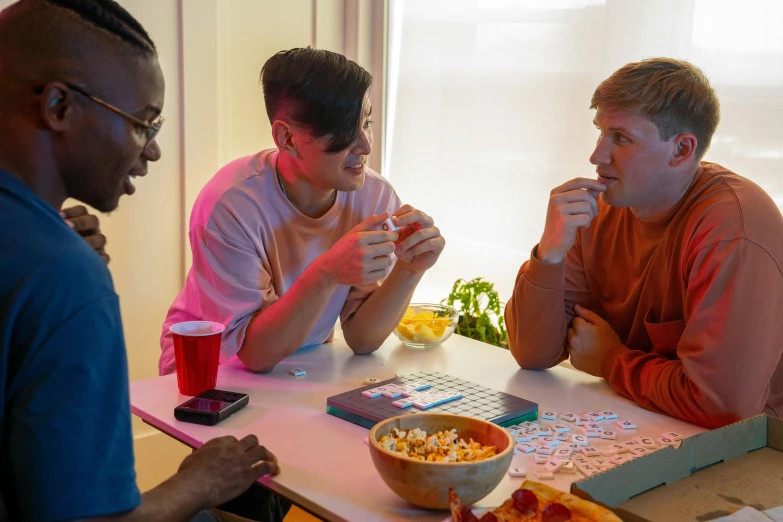 a group of men sitting around a table eating pizza, pexels contest winner, showing a screen playing tetris, bisexual lighting, corn chess board game, charli bowater and artgeem