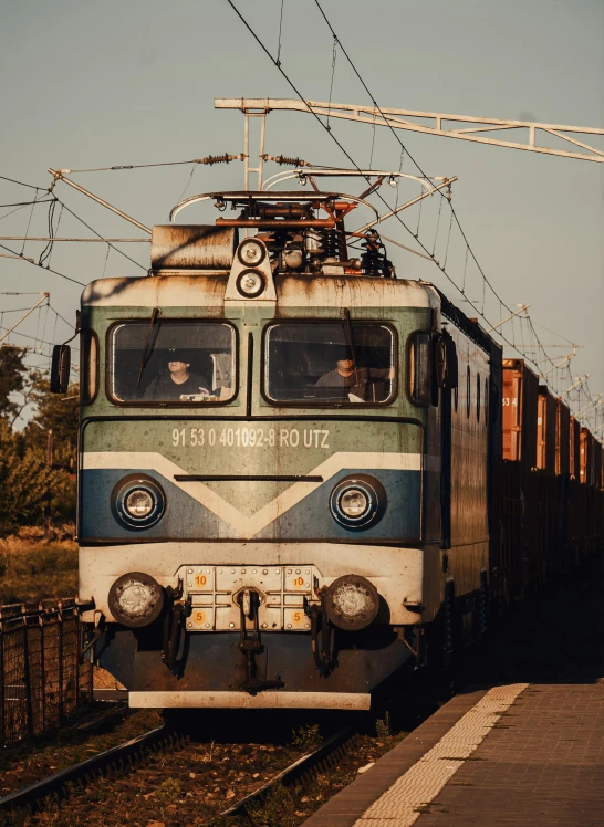 a train traveling down train tracks next to a train station, a portrait, by Adam Marczyński, full frame image, cinematic silk road lanscape, thumbnail, multiple stories