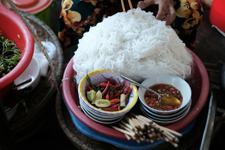 a couple of bowls of food sitting on top of a table, a picture, cambodia, dry ice, background image, barong family member