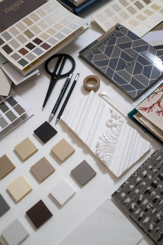 a table topped with lots of different types of tile, inspired by Lewis Henry Meakin, unsplash, fabrics, architectural planning, taupe, brand identity