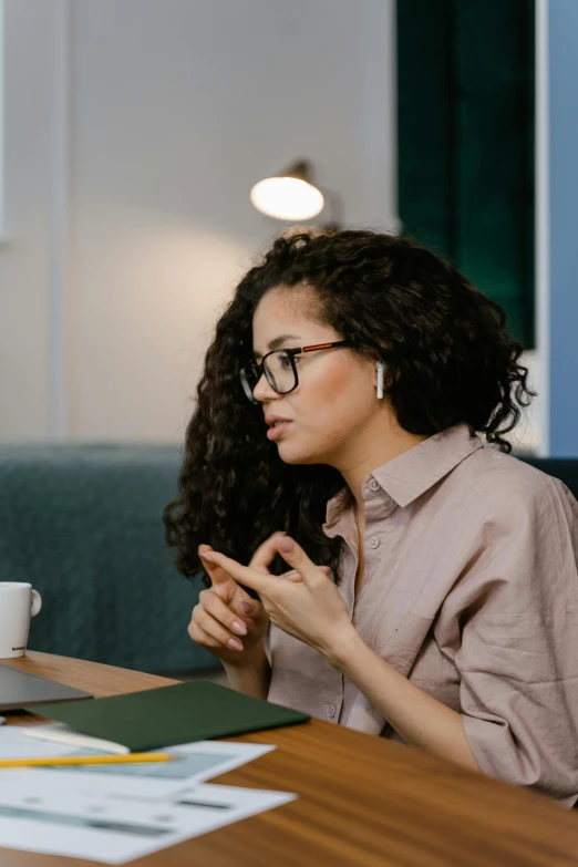 two women sitting at a table talking to each other, trending on pexels, realism, looking serious, diary on her hand, wearing black rimmed glasses, thinking pose